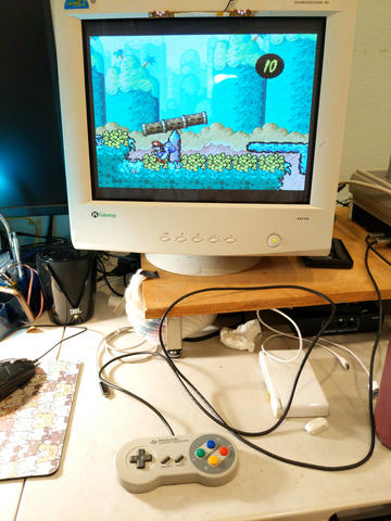 Photo of SNES controller connected to a Wii's GameCube ports playing SMW2